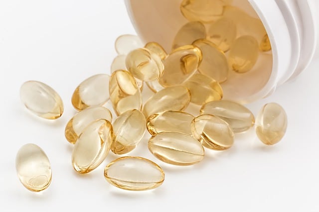 Vitamin E supplement capsules on a white background.