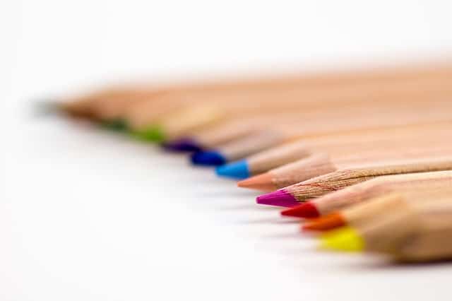 A row of colored pencils on a white background